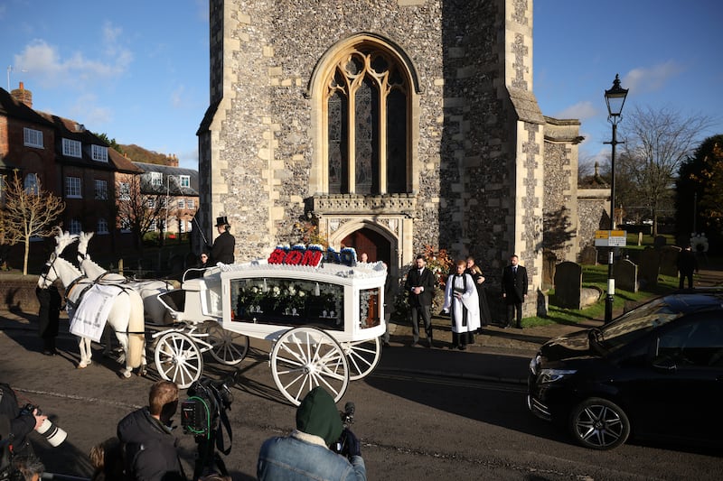 A white horse drawn hearse carrying the coffin of former One Direction singer Liam Payne arrives at a church in Amersham, Buckinghamshire. Photograph: Dan Kitwood/Getty Images