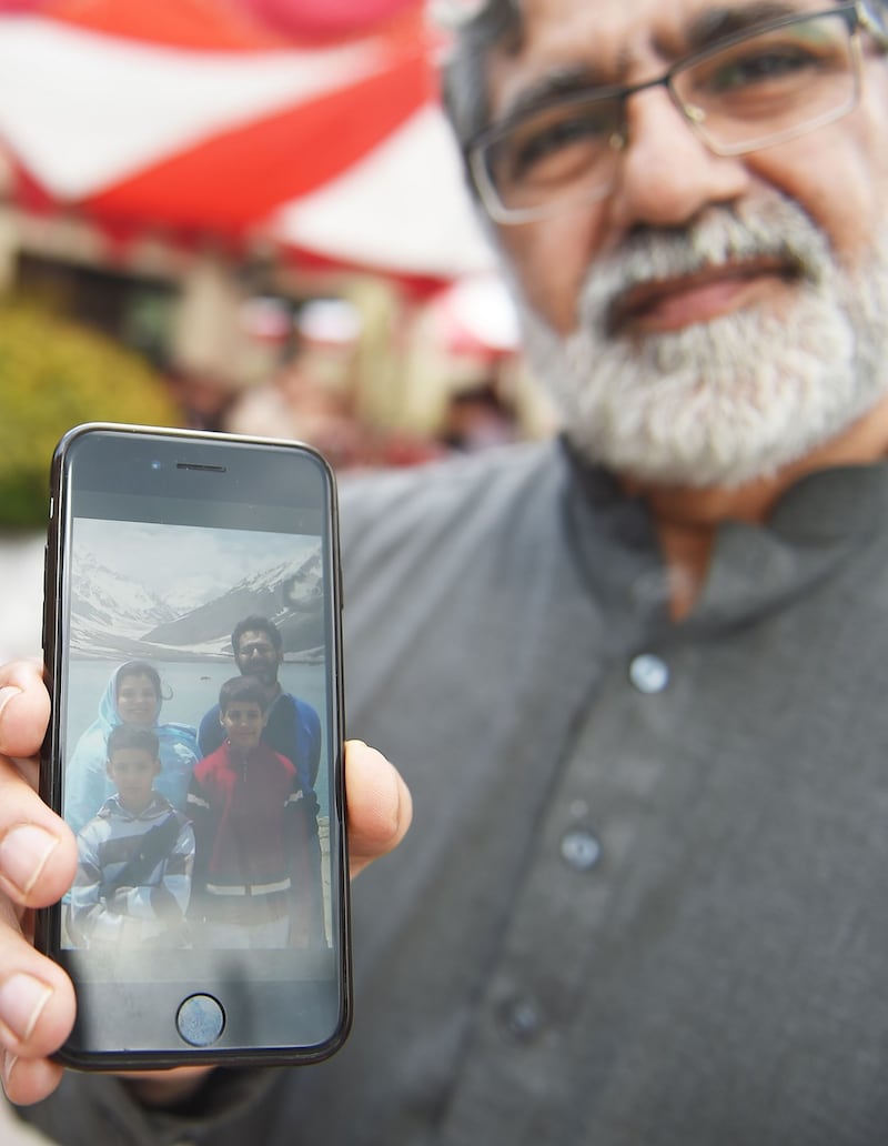 Rizwan Rashid, brother of Pakistani national Naeem Rashid, who was killed in the attacks to the Christchurch mosques in New Zealand, shows his family picture. Photograph: Farooq Naeem/AFP/Getty