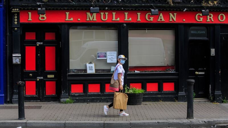 A person passes Mulligan’s pub in Stoneybatter, Dublin. Photograph: Gareth Chaney/Collins