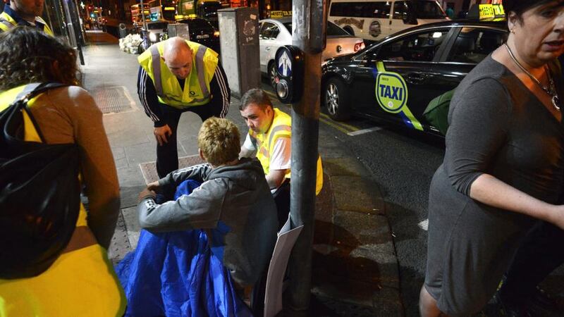 Volunteers with Inner City Helping the Homeless in conversation with a homeless person in Dublin city centre. Photograph: Dave Meehan