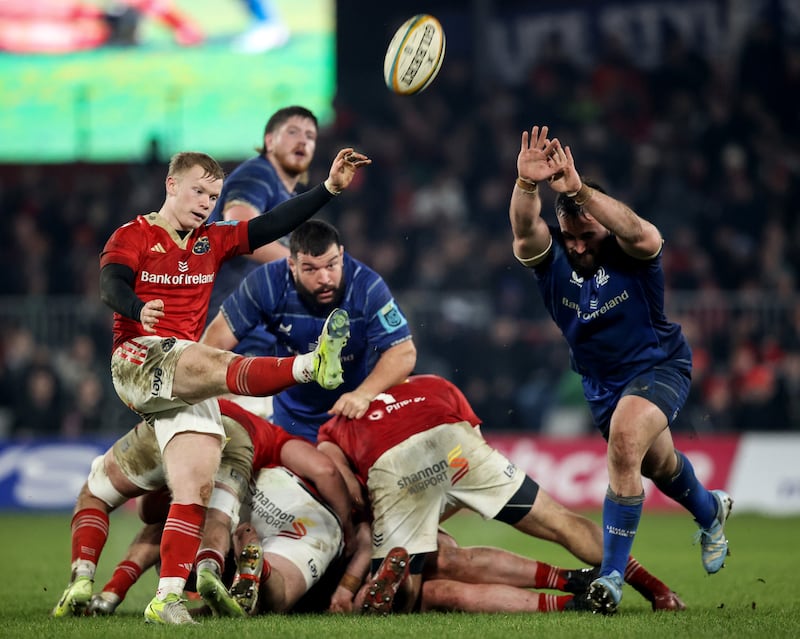 Munster's Ethan Coughlan gets a box kick away despite the pressure from Ronan Kelleher of Leinster at Thomond Park. Photograph: Ben Brady/Inpho 