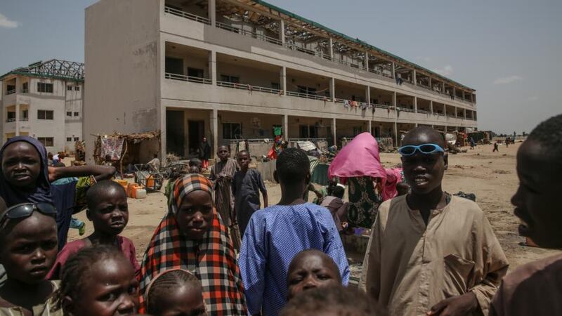 Displaced people collect water in Muna customs camp on the outskirts of Maiduguri, northeast Nigeria. Photograph: Sally Hayden