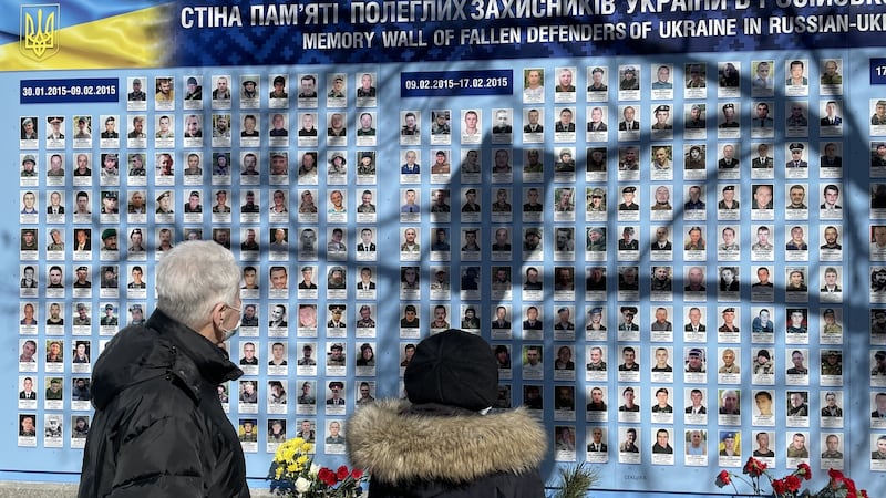 A couple in Kyiv visit a memorial wall for soldiers killed in the country’s eight-year conflict with Russia. Photograph: Daniel McLaughlin