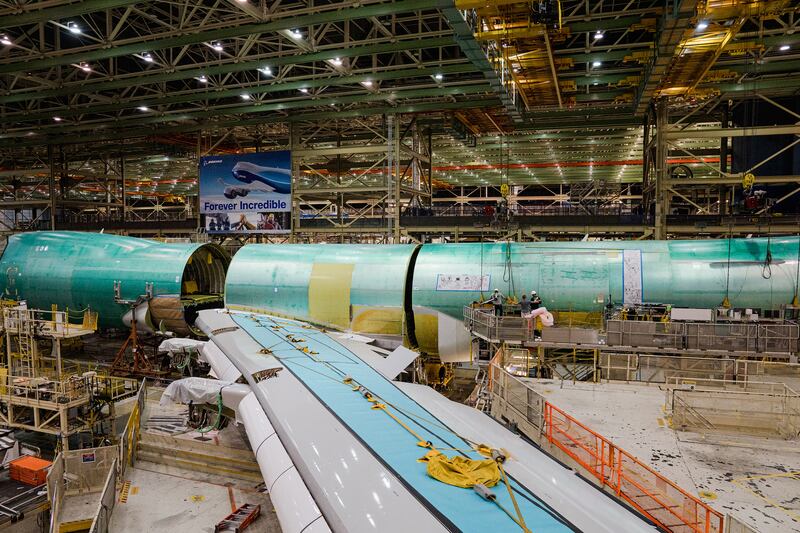 Cranes lift the rear fuselage into position during the final body join. Photograph: Jovelle Tamayo/The New York Times