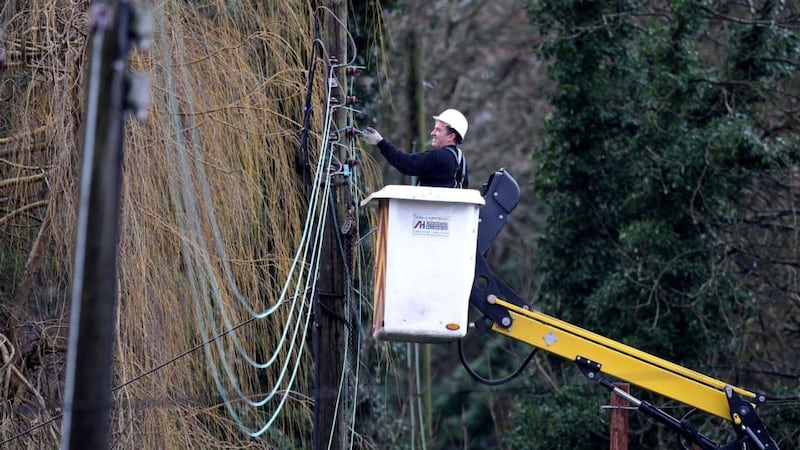 A workman works on repairing electricity lines on Christmas Day near Reigate in Surrey in the UK after floods hit the area. Weather agencies in Ireland and Britain have issued a fresh storm warning for this evening. Photograph: PA