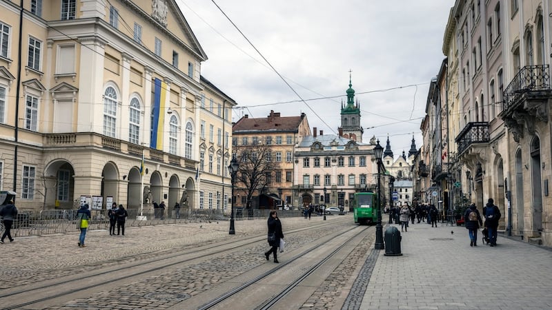 Pedestrians on the street in front of City Hall in Lviv, Ukraine. For millions of internally displaced Ukrainians, Lviv is the gateway to safety, however fleeting, in the west. Photograph: Ivor Prickett/ The New York Times