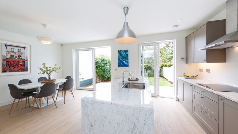 Kevin Houlihan knocked the dividing wall between the kitchen  and the dining room to create a modern space the width of the house that had room for a decent dining table as well as a long stone-topped island.