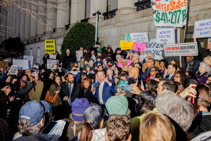 Senator Chris Murphy  speaks during a protest against the department of government efficiency, outside the treasury department in Washington. Photograph: Jason Andrew/New York Times
                      