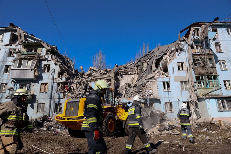 Ukrainian rescuers work on the five-storey residential building destroyed after a missile strike in Zaporizhzhia. Photograph: Katerina Klochko/AFP via Getty