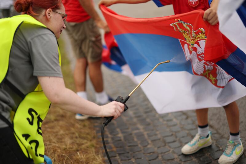 A steward sprays a National Flag of Serbia with a fire retardant outside the stadium prior to the match against Slovenia. Photograph: Recine/Getty Images