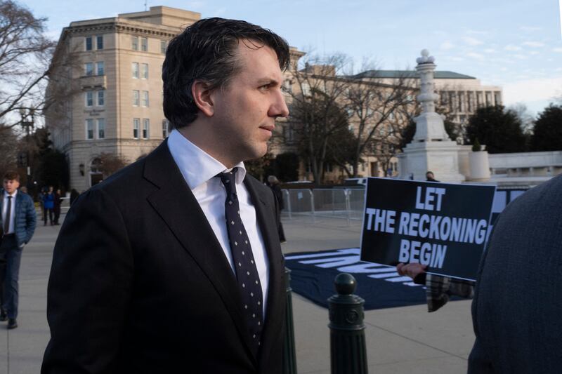 Jason Murray, the lead attorney for the Colorado voters in the lawsuit, walks past anti-Trump demonstrators outside the US supreme court as it considers whether former US president Donald Trump is eligible to run for president in the 2024 election. Photograph: Roberto Schmidt/AFP via Getty Images