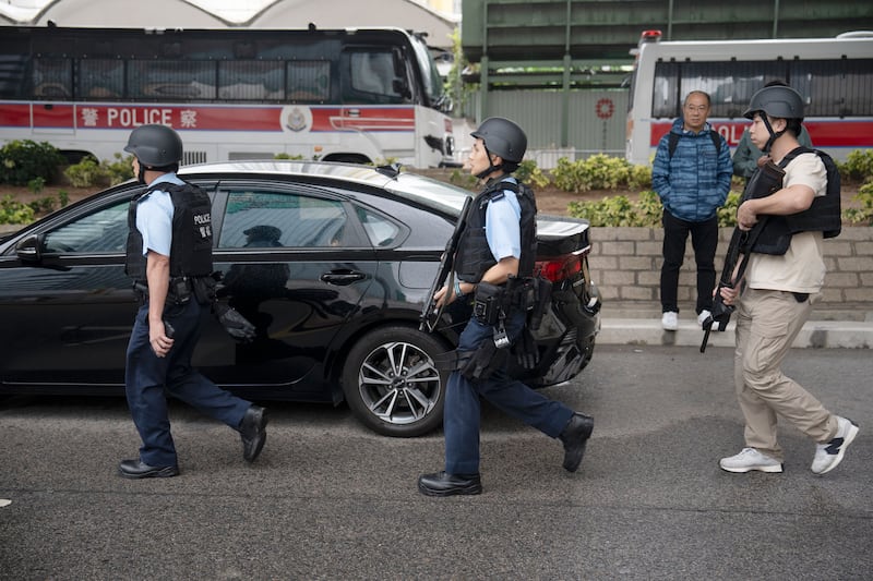 Police officers walk outside the court before hearing the sentence for 45 Hong Kong pro-democracy activists. Photograph: Leung Man Hei/EPA