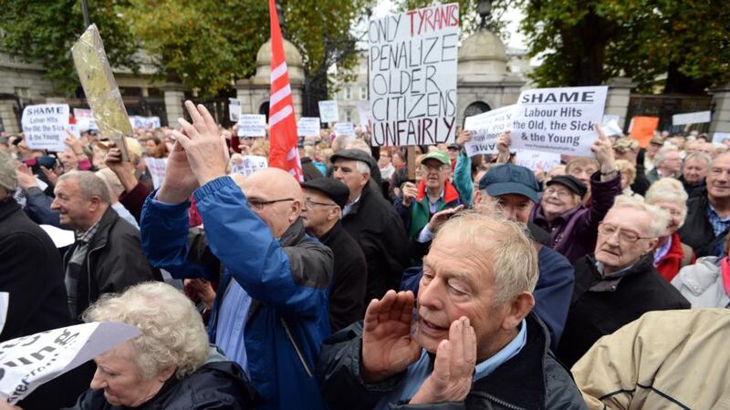 People take part in a protest rally over Budget 2014 cuts affecting  elderly,  sick and  vulnerable persons  outside Leinster House in Dublin today. Photograph: Eric Luke/The Irish Times