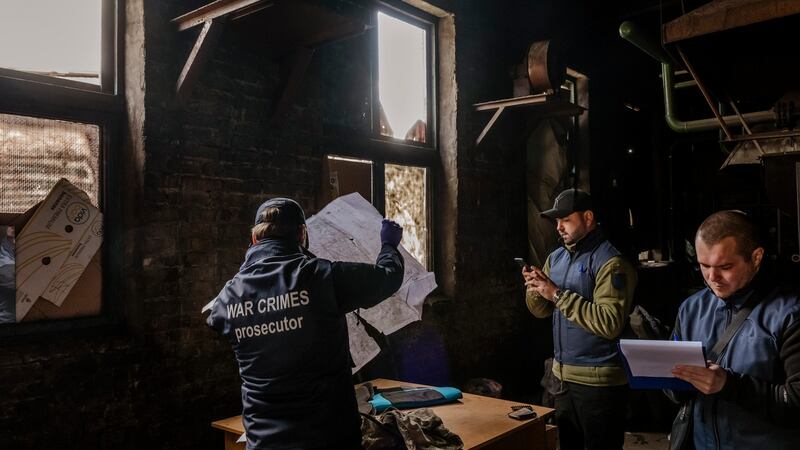 The prosecutor Ruslan Kravchenko (left) leads a search of a Russian base, in Bucha, Ukraine. Photograph: Daniel Berehulak/The New York Times