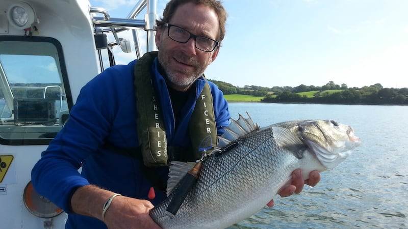 Telemetry expert Finn Okland holds a satellite tagged bass prior to its return to the water in Cork harbour.