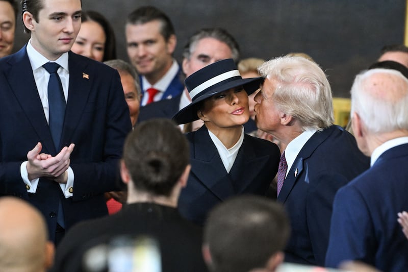 US President-elect Donald Trump kisses Melania Trump as he arrives for the inauguration ceremony before he is sworn in as the 47th US President in the US Capitol Rotunda in Washington, DC.