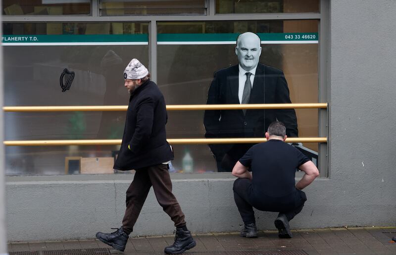 Joe Flaherty Fianna of Fáil installs window posters in Longford town. Photograph: Nick Bradshaw