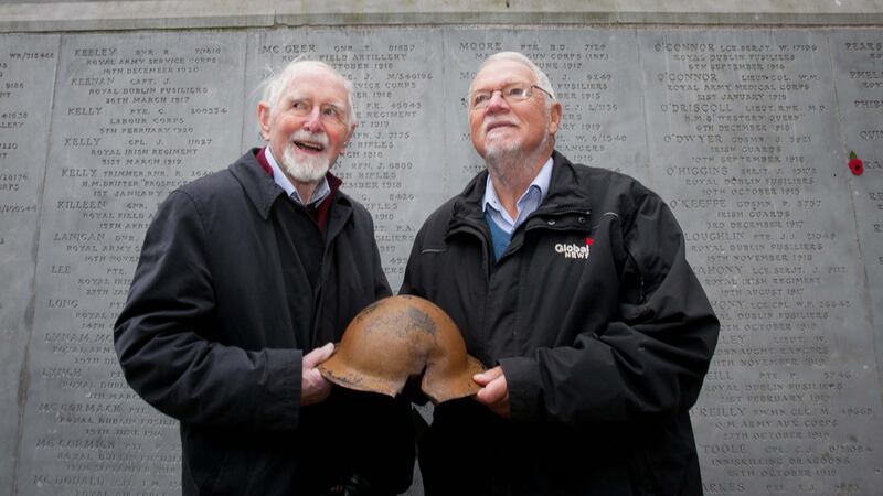 Michael Andrews (left) and Vincent Murphy, both from Mount Merrion, with a helmet owned by Michael’s father William Andrews (who fought with the Royal Engineers in the first World War), at Glasnevin Trust Armistice Day commemorations at Glasnevin Cemetery, Dublin. Photograph: Gareth Chaney/Collins