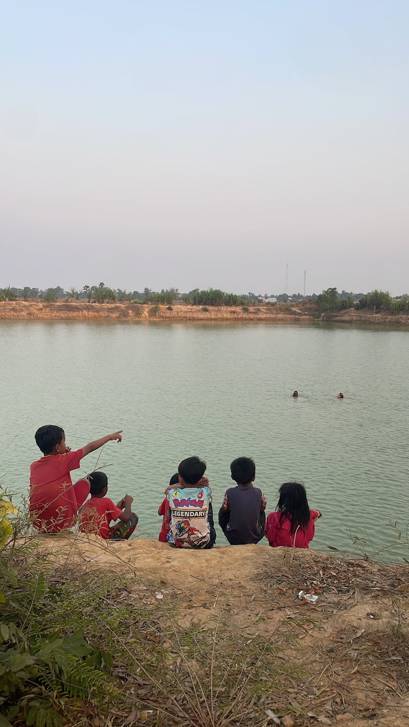 Volunteers swimming with local children at the village lake