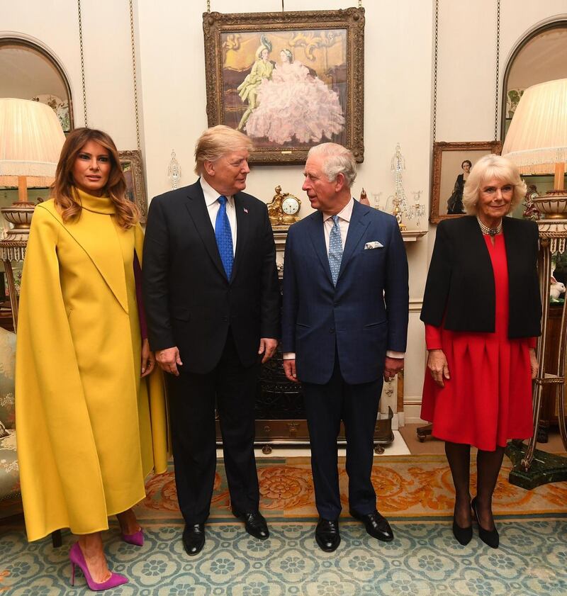 Clarence House: Melania Trump kept her cape on to meet Prince Charles and Camilla. Photograph: Victoria Jones/WPA Pool/Getty