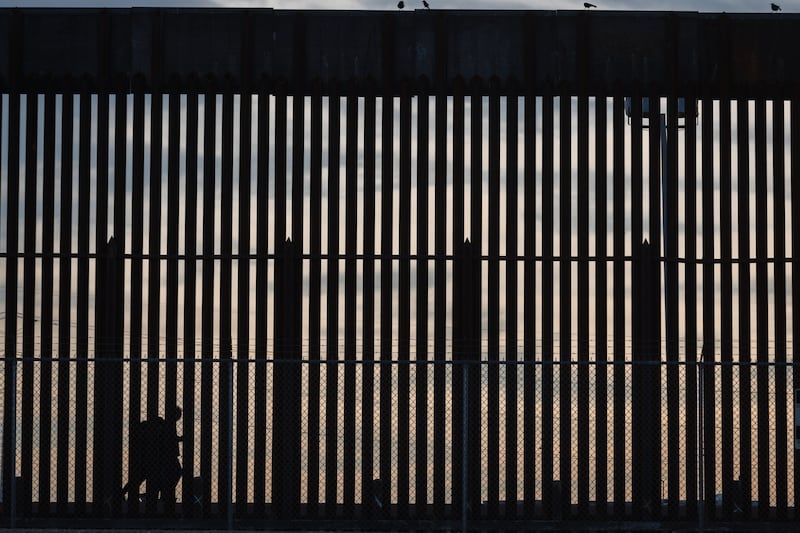 People walk along the United States border with Mexico in El Paso, Texas, US, on Tuesday. Photograph: Justin Hamel/EPA