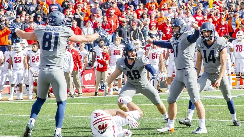 Illinois Fighting Illini place kicker James McCourt celebrates landing his winning kick with team-mates Griffin Palmer (81), Bryce Barnes (48) and   Blake Hayes (14). Photograph: University of Illinois Athletics