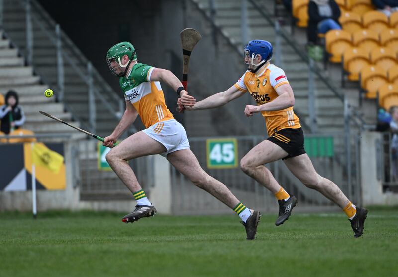 Brian Duignan of Offaly in action with Eoin McFerran of Antrim during the NHL clash. Photograph: Andrew Paton/Inpho