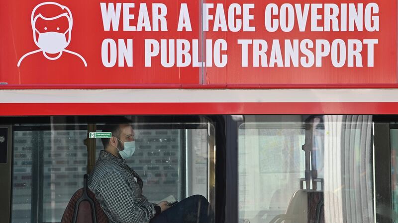 A man travels on a bus wearing a face mask in central London. Minister for Transport Shane Ross is set to bring the compulsory mask proposals to Thursday’s Cabinet meeting. Photograph: Justin Tallis / AFP