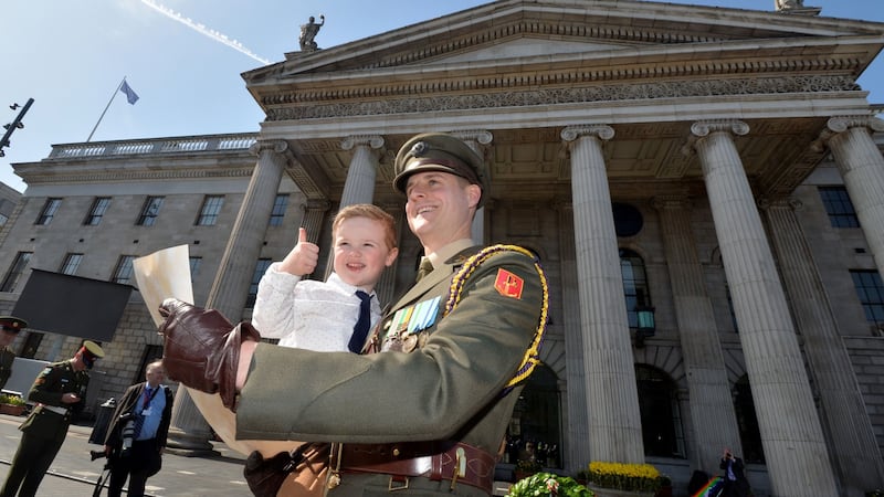 Capt Paul Conlon with his son Senan (3) after reading the Proclamation during an event at the GPO  marking the 103rd anniversary of the Rising. Photograph: Alan Betson/The Irish Times