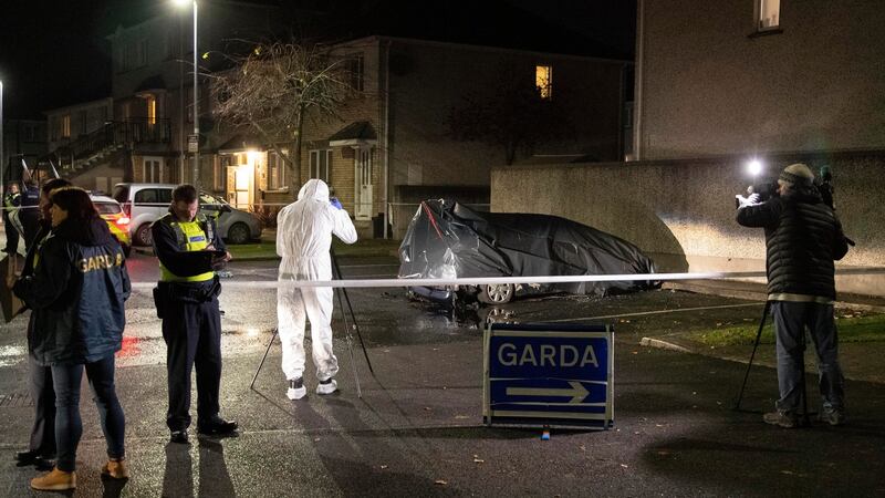 Gardaí at the scene  where the body of man was discovered inside a burning vehicle on Monday night. Photograph: Collins