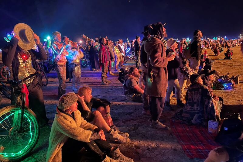 Remaining attendees at the Burning Man festival watch the burning of the Chapel of Babel, a work of art by Michael Burlington, early on Tuesday morning. Photograph: Julie Jammot/AFP via Getty Images