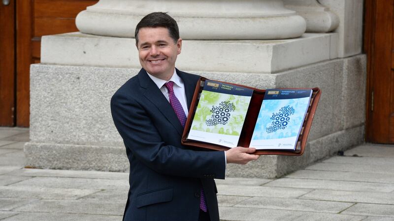 Minister for Finance Paschal Donohoe with his budget book at Government Buildings last year. A new report hints at changes to the carbon tax and 9 per cent VAT rate for hospitality businesses. File photograph: Cyril Byrne/The Irish Times