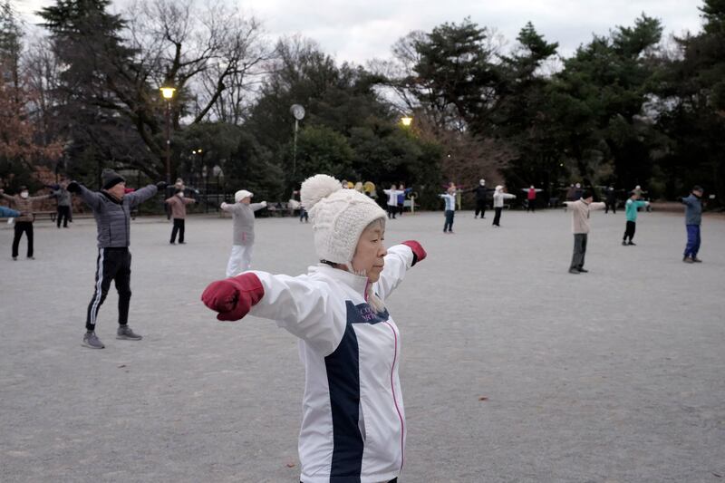 People gather early in the morning in Tokyo to do the short exercise routine known as radio taiso. Photograph: Kosuke Okahara/The New York Times