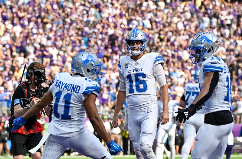  Jared Goff celebrates with Kalif Raymond and Amon-Ra St. Brown after a Detroit Lions touchdown against the Minnesota Vikings. Photograph: Stephen Maturen/Getty Images