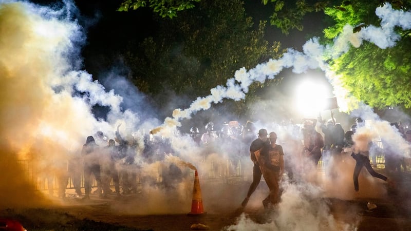 Tear gas rises as protesters face off with police during a demonstration outside the White House in Washington on Sunday. Photograph:  Samuel Corum/AFP via Getty Images