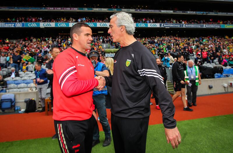 Louth manager Ger Brennan with Donegal manager Jim McGuinness. Photograph: Ryan Byrne/Inpho