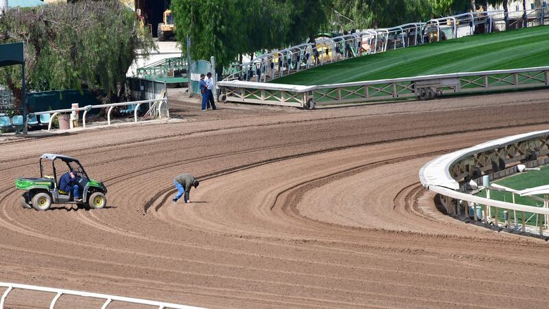 Samples and measurements are taken on the dirt track at Santa Anita Racetrack in Arcadia, California. Photograph: Frederic J Brown/AFP/Getty Images