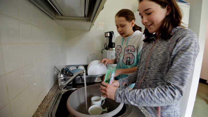 Eveline Lutere and Emily Ginty washing up and drying dishes  at a NCBI residential summer camp  for visually impaired children aged 13-18, learning independent living skills. Photograph: Alan Betson / The Irish Times