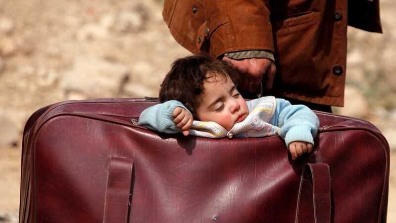 A child sleeps in a bag in the village of Beit Sawa, eastern Ghouta, Syria on Thursday. Photograph: Omar Sanadiki/Reuters