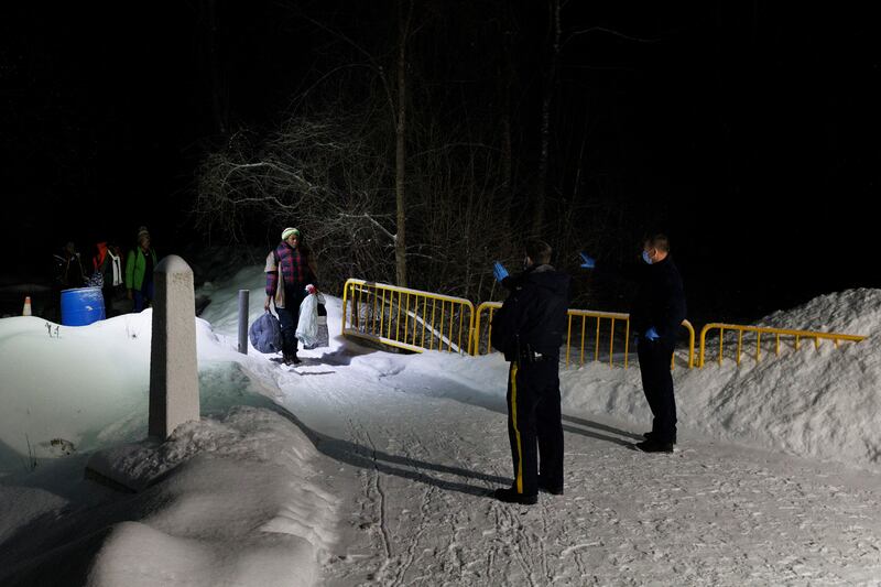 Migrants arrive at the Roxham Road border crossing in Saint-Bernard-De-Lacolle, Quebec, Canada, from New York state. Photograph: Nasuna Stuart-Ulin/The New York Times
                      