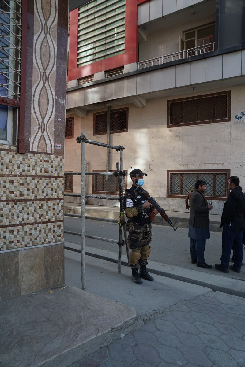 A Taliban soldier guarding a meeting between Hazara and Taliban leaders in Kabul. Photograph: Hannah McCarthy