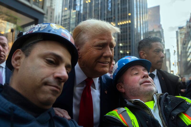 Donald Trump receiving an early morale boost during a meeting with union workers at the construction site in Manhattan. Photograph: Hiroko Masuike/New York Times
                      