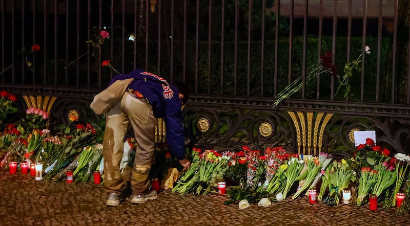 A man lays a flowers in memory of the victims of the terrorist attack on the Crocus City Hall in Krasnogorsk at the Russian embassy in Berlin, Germany. Photograph: Hannibal Hanschke/Shutterstock