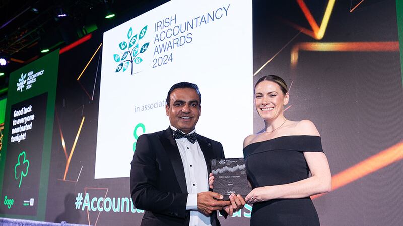 Irfan Hameed, chief executive, Intax, presents the CSR initiative of the year award to Anna Savage, Fexco