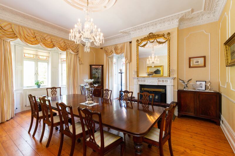 The diningroom has a fine marble fireplace and two bay windows, drawing light from north and west.