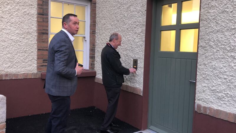 Transport Shane Ross rings the bell at the newly reopened Stepaside Garda station.  Photograph: Simon Carswell