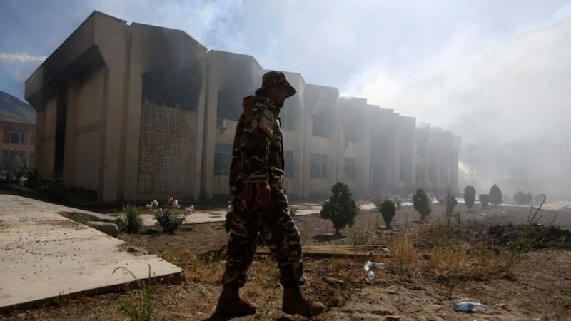 An Afghan security officer walks in front of a Panjshir government building after an attack by six Taliban suicide bombers  in Panjshir province last month. Photograph: Omar Sobhani/Reuters