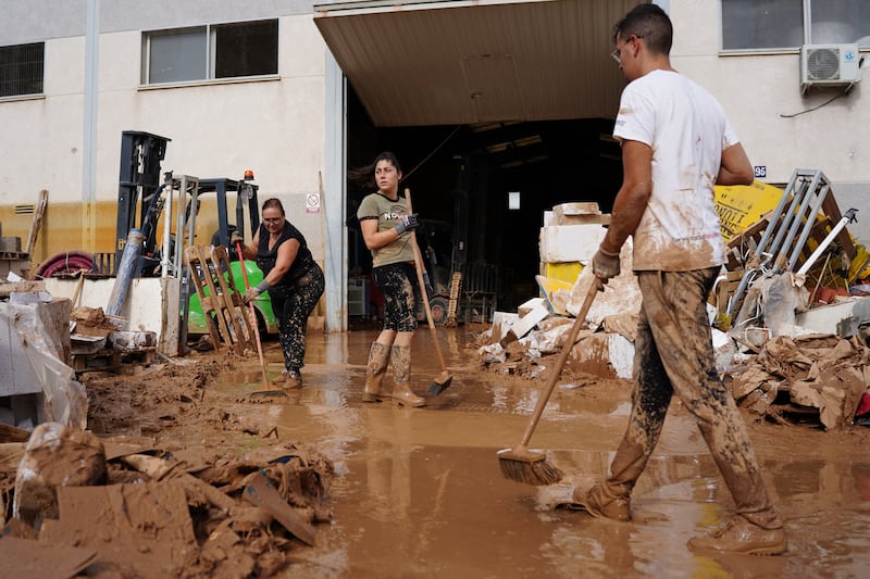 People try to clean a street covered in mud in Paiporta, Valencia in eastern Spain. Photograph: Manaure Quintero/AFP/Getty Images