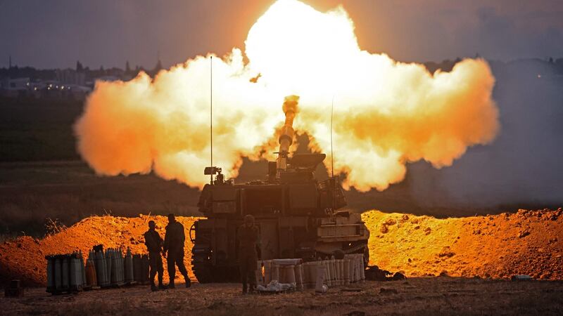 Israeli soldiers fire a 155mm  howitzer round at the Gaza Strip from their position along the border with the Palestinian enclave. Photograph: Emmanuel Dunand/AFP/Getty