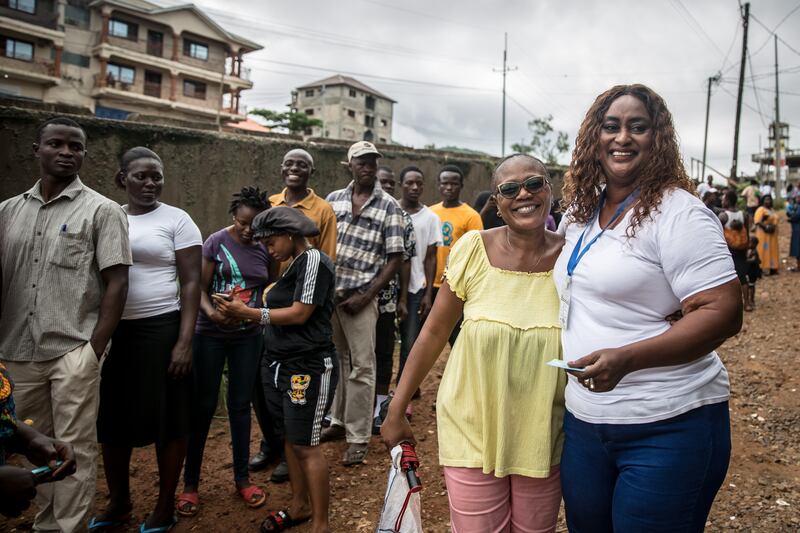 Zinabu Timbo, an MP candidate for Western Rural Area Goderich, greets supporters on her way to vote in Lakka, Freetown. Photograph: Sally Hayden